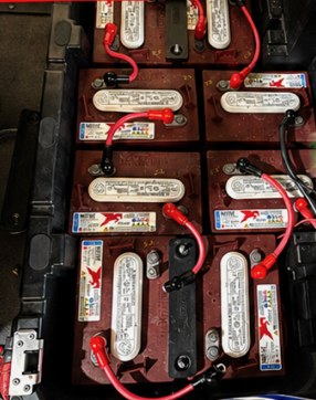 Before: six lead-acid batteries wired together in a golf cart battery bay